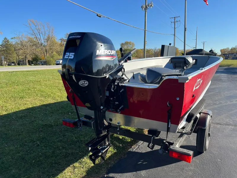 Slide: The Image of 2025 Lund 1600 Fury Tiller boat with Mercury 25 outboard motor on trailer. - 4