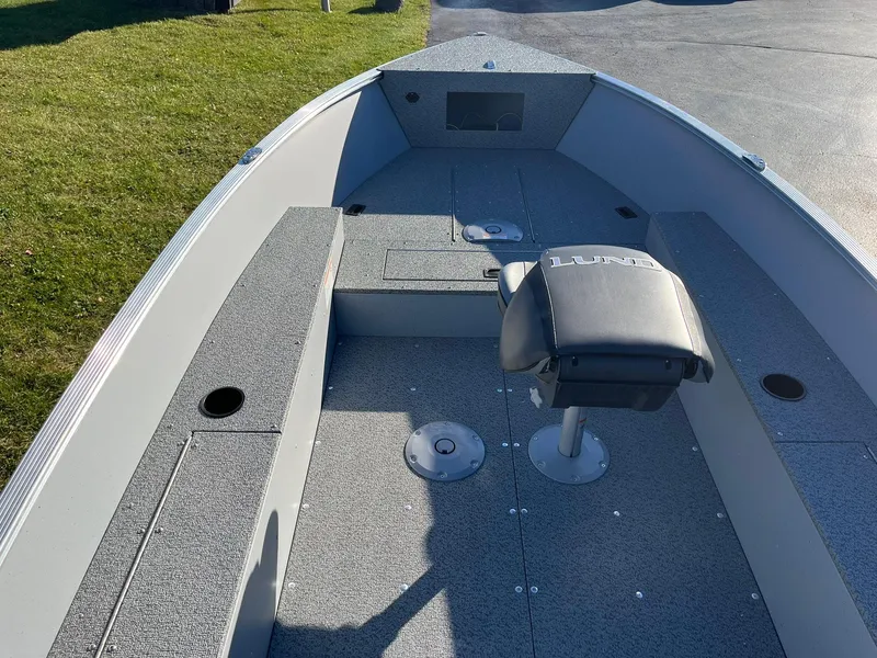 Slide: The Image of 2025 Lund 1600 Fury Tiller boat interior with seating and storage compartments. - 6