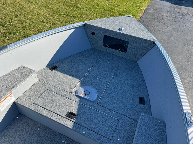 Slide: The Image of 2025 Lund 1600 Fury Tiller boat interior with storage compartments and seating. - 8