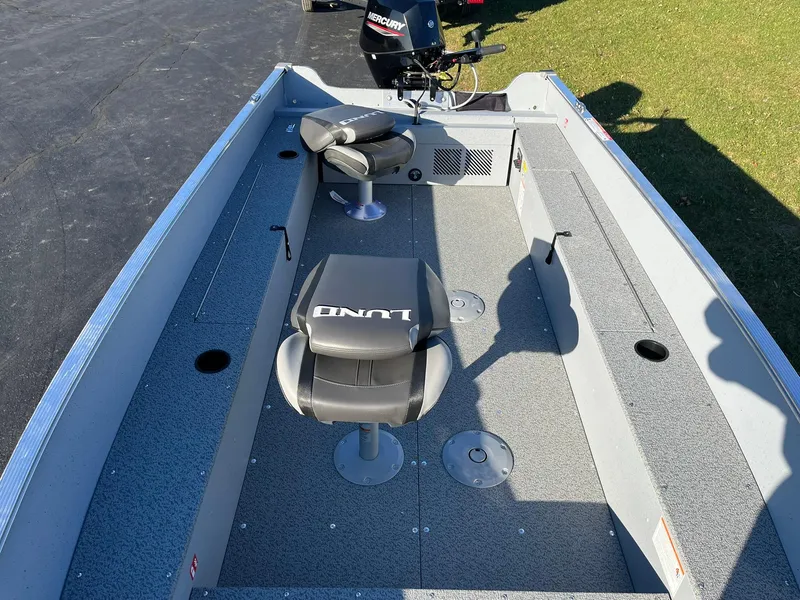 Slide: The Image of 2025 Lund 1600 Fury Tiller boat interior with seating and motor. - 9