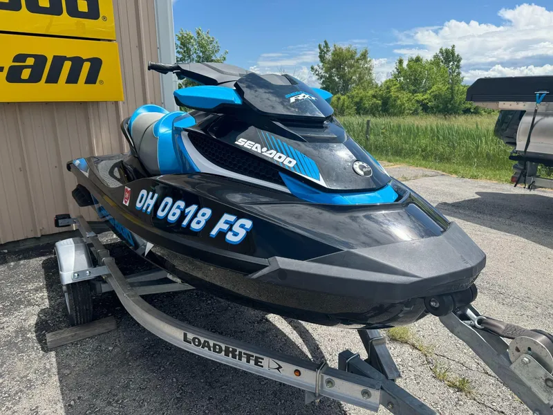 Slide: The Image of 2017 Sea-Doo RXT 260 jet ski on trailer, parked outdoors. - 1