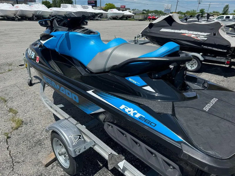Slide: The Image of 2017 Sea-Doo RXT 260 jet ski on trailer in parking lot. - 2