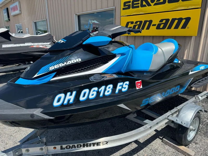 Slide: The Image of 2017 Sea-Doo RXT 260 jet ski on trailer, black and blue design. - 3