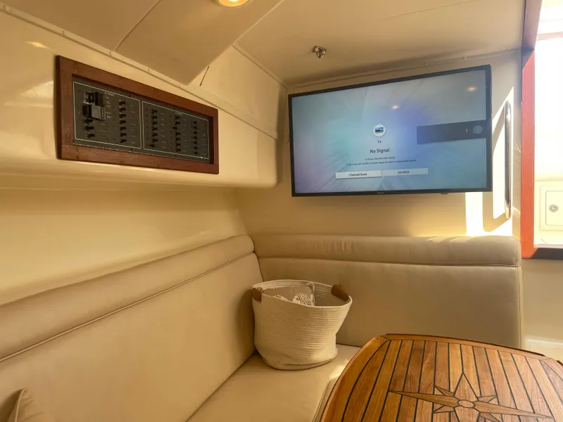 Slide: The Image of Interior of 2006 Carolina Classic 35 boat with TV and seating area. - 11