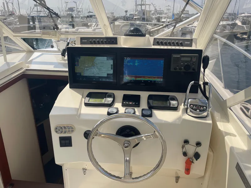 Slide: The Image of Helm of 2006 Carolina Classic 35 boat with navigation equipment and steering wheel. - 15