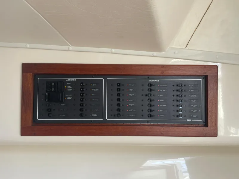 Slide: The Image of Electrical panel on a 2006 Carolina Classic 35 boat, featuring AC and DC power controls. - 17