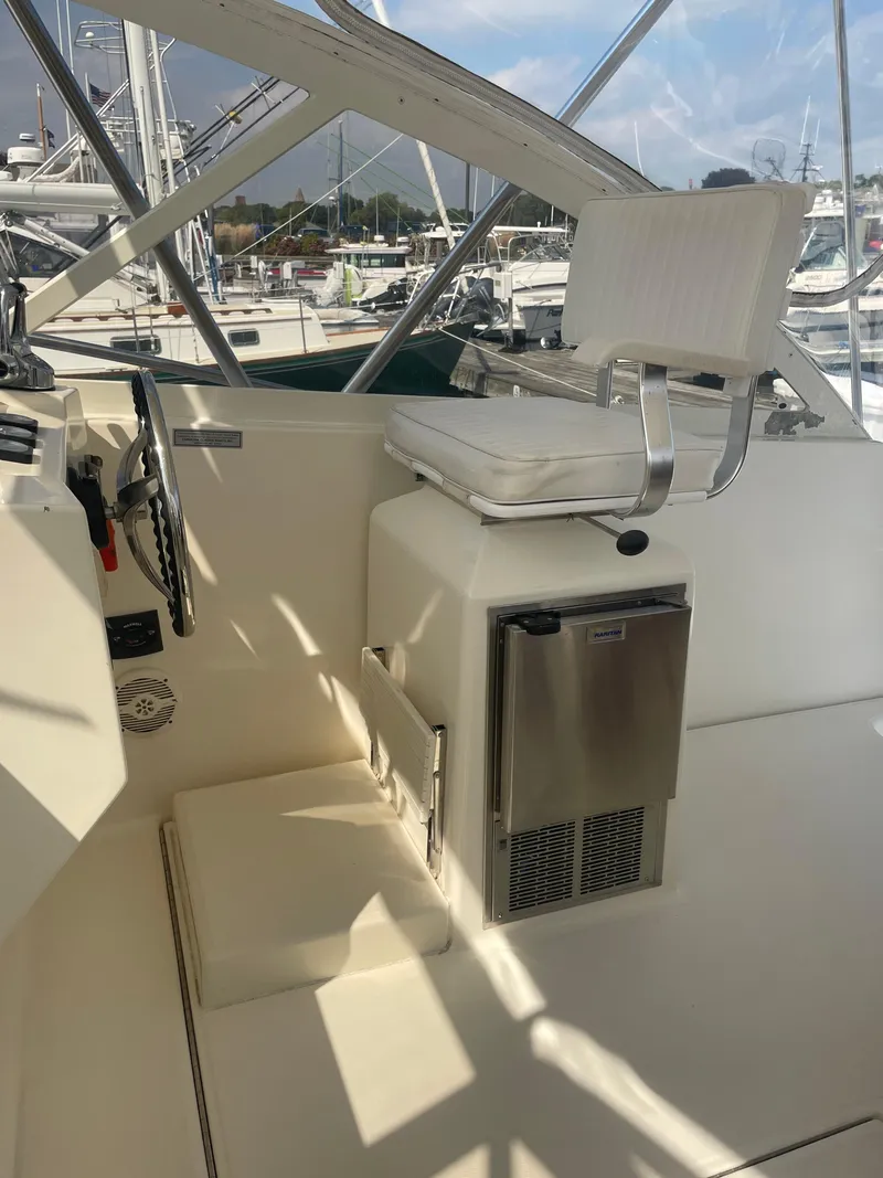 Slide: The Image of 2006 Carolina Classic 35 boat helm with seat and mini fridge. - 18
