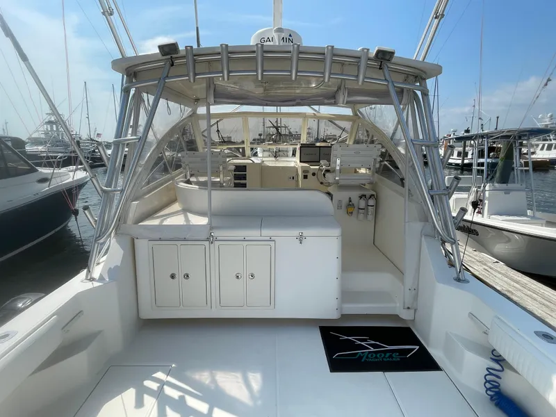 Slide: The Image of 2006 Carolina Classic 35 boat interior at marina, featuring helm and storage compartments. - 6