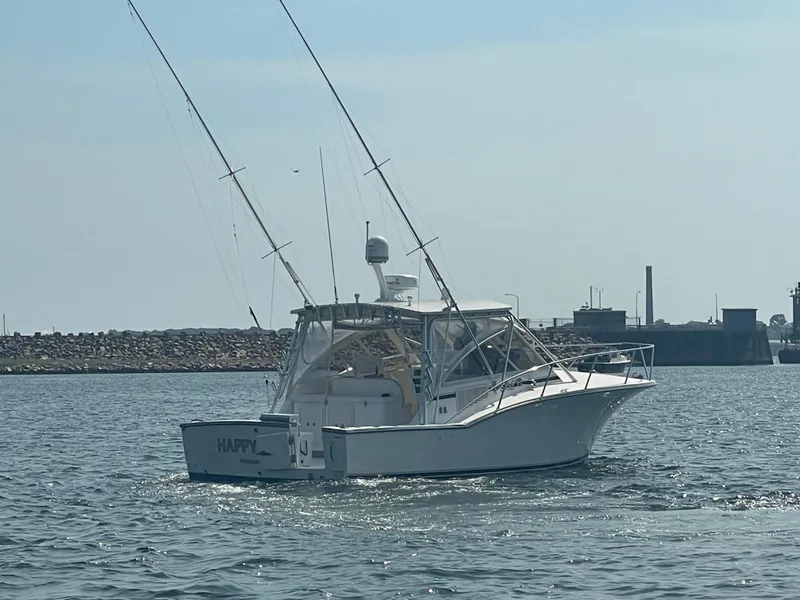 Slide: The Image of 2006 Carolina Classic 35 boat on water, clear sky, industrial background. - 8