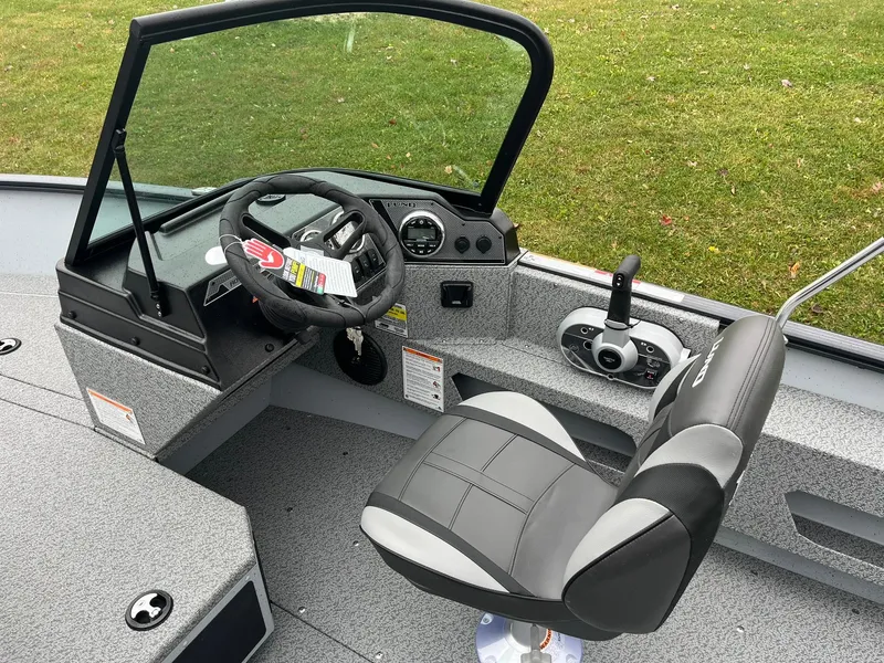 Slide: The Image of 2025 Lund 1775 Adventure Sport boat interior with steering wheel and seat. - 11