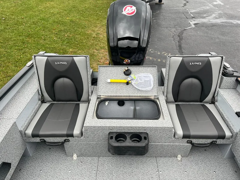 Slide: The Image of 2025 Lund 1775 Adventure Sport boat interior with two seats and storage compartment. - 12