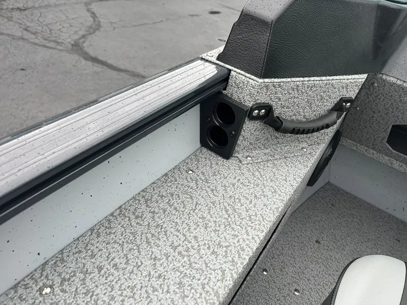 Slide: The Image of 2025 Lund 1775 Adventure Sport boat interior with textured flooring and cup holders. - 19