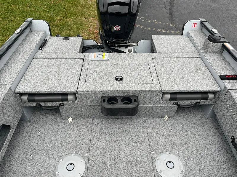 Slide: The Image of 2025 Lund 1775 Adventure Sport boat interior with storage compartments and motor. - 7