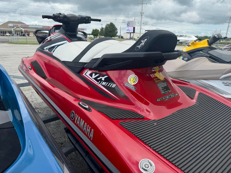 Slide: The Image of 2016 Yamaha WaveRunner VX Limited in red, parked outdoors on a cloudy day. - 2