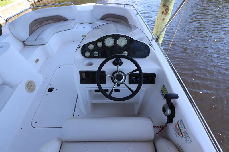 Slide: The Image of 2005 Hurricane FunDeck GS 201 OB boat interior with steering wheel and seating. - 13