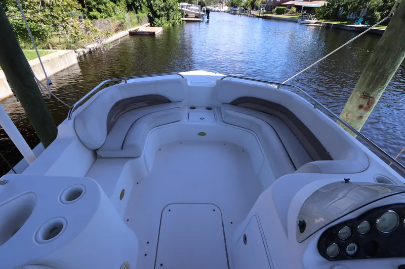 Slide: The Image of 2005 Hurricane FunDeck GS 201 OB boat interior with spacious seating on a calm waterway. - 14