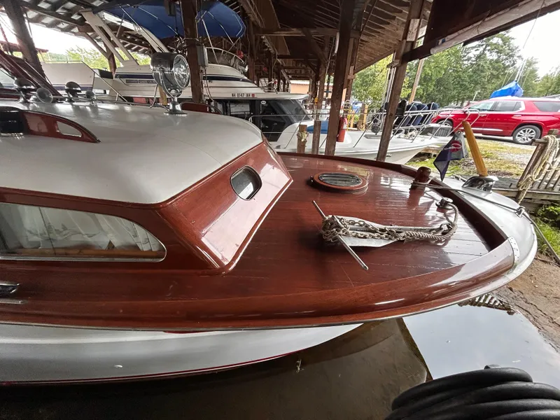 Slide: The Image of 1954 Chris-Craft Commander 336 Express Cruiser with wooden deck in a marina. - 10