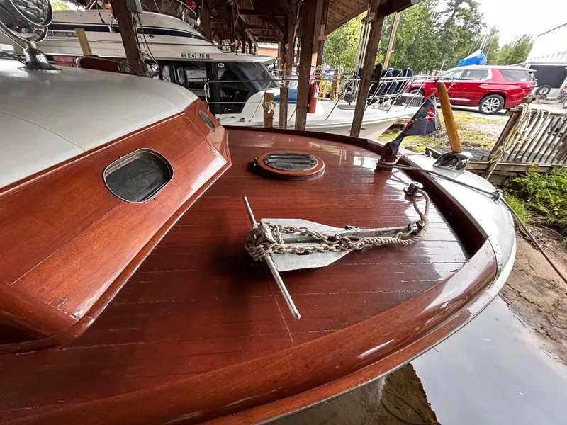 Slide: The Image of 1954 Chris-Craft Commander 336 Express Cruiser with wooden deck and anchor, docked in a marina. - 11