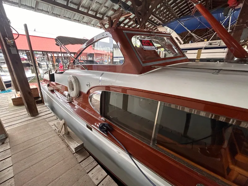 Slide: The Image of 1954 Chris-Craft Commander 336 Express Cruiser docked in a marina. - 12