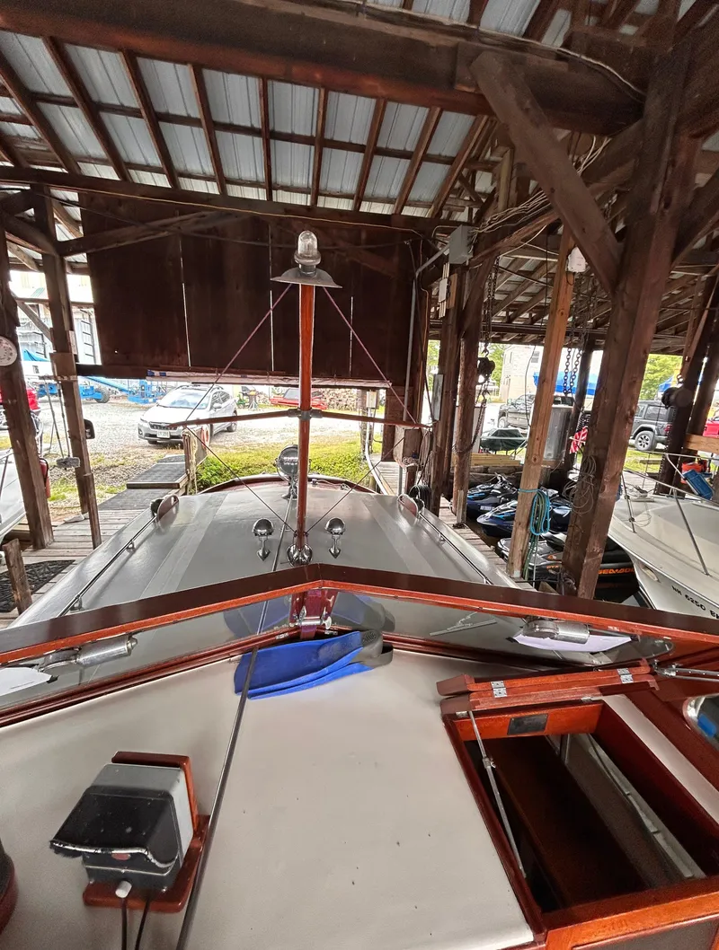 Slide: The Image of 1954 Chris-Craft Commander 336 Express Cruiser docked in a wooden boathouse. - 13