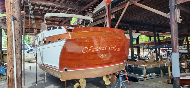 Slide: The Image of 1954 Chris-Craft Commander 336 Express Cruiser in a boatyard, named "Victoria Rose." - 14