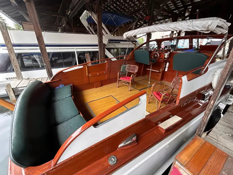 Slide: The Image of 1954 Chris-Craft Commander 336 Express Cruiser with wooden deck and seating in marina. - 15