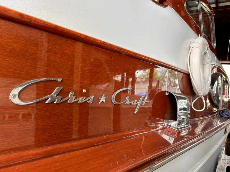 Slide: The Image of 1954 Chris-Craft Commander 336 Express Cruiser with polished wood finish and logo detail. - 16