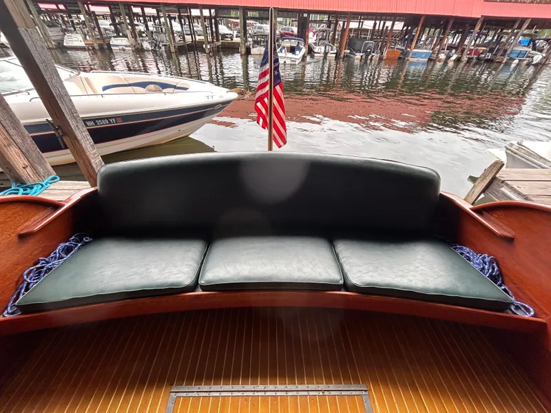 Slide: The Image of 1954 Chris-Craft Commander 336 Express Cruiser with leather seating, docked by the water. - 18