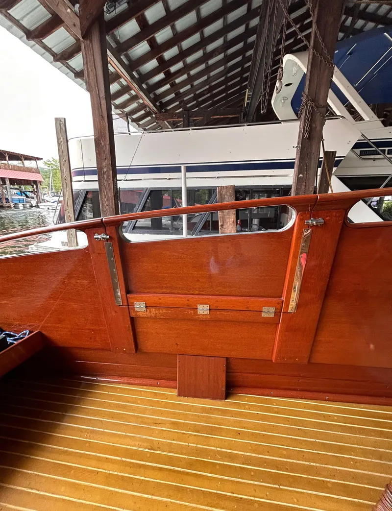 Slide: The Image of 1954 Chris-Craft Commander 336 Express Cruiser with polished wood interior under a covered dock. - 19
