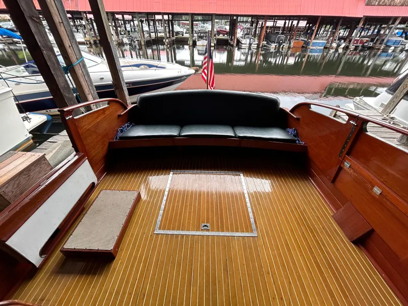 Slide: The Image of 1954 Chris-Craft Commander 336 Express Cruiser interior with wooden deck and seating. - 20