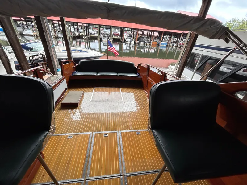 Slide: The Image of 1954 Chris-Craft Commander 336 Express Cruiser interior with wooden deck and seating. - 23