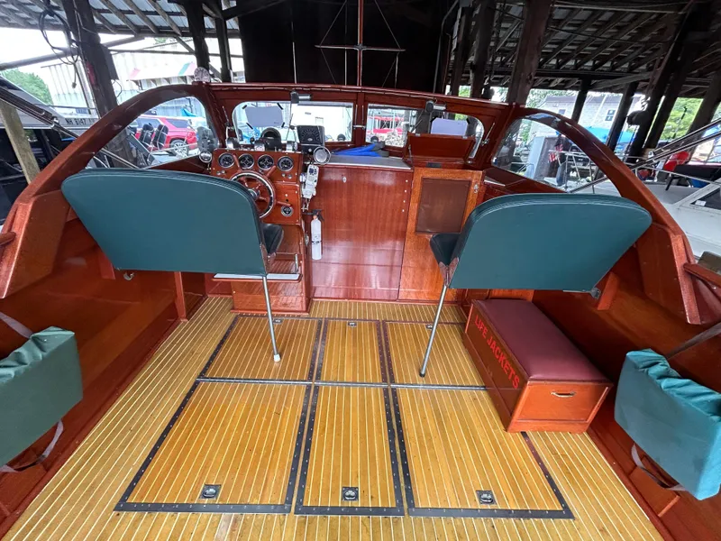 Slide: The Image of 1954 Chris-Craft Commander 336 Express Cruiser interior with wooden finish and green seating. - 24