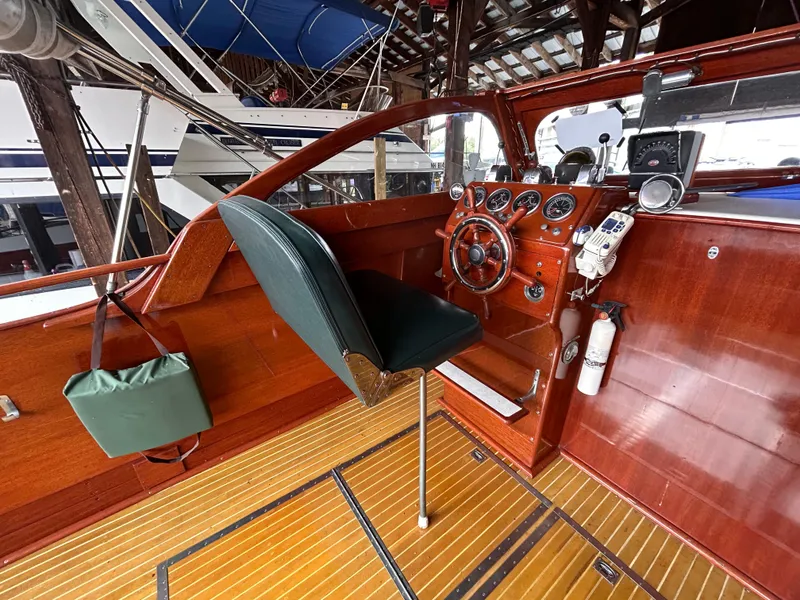 Slide: The Image of 1954 Chris-Craft Commander 336 Express Cruiser helm with vintage wood finish and classic controls. - 25
