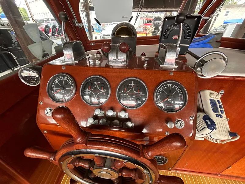 Slide: The Image of Vintage 1954 Chris-Craft Commander 336 Express Cruiser dashboard with classic wooden steering wheel. - 29