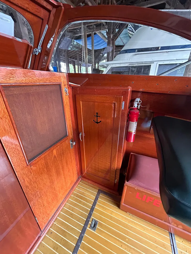 Slide: The Image of Interior of 1954 Chris-Craft Commander 336 Express Cruiser with wooden paneling and fire extinguisher. - 33