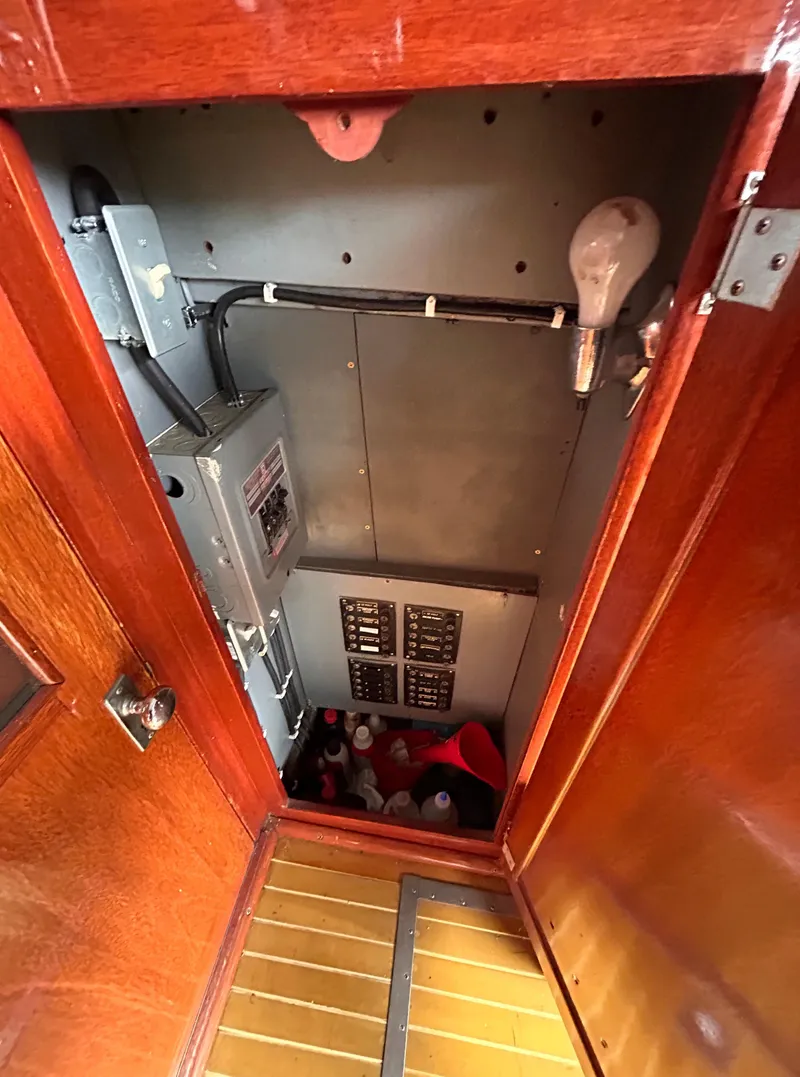 Slide: The Image of Electrical panel inside 1954 Chris-Craft Commander 336 Express Cruiser with wooden cabinetry. - 35