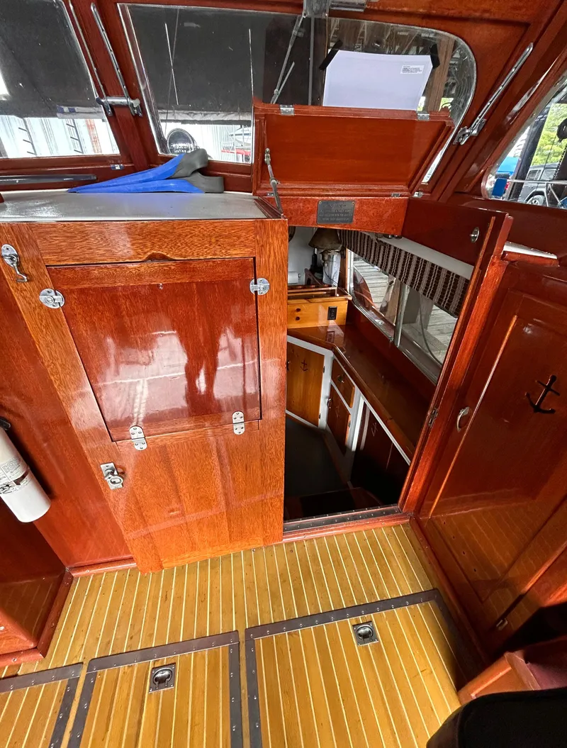 Slide: The Image of 1954 Chris-Craft Commander 336 Express Cruiser interior with polished wood and nautical design. - 36