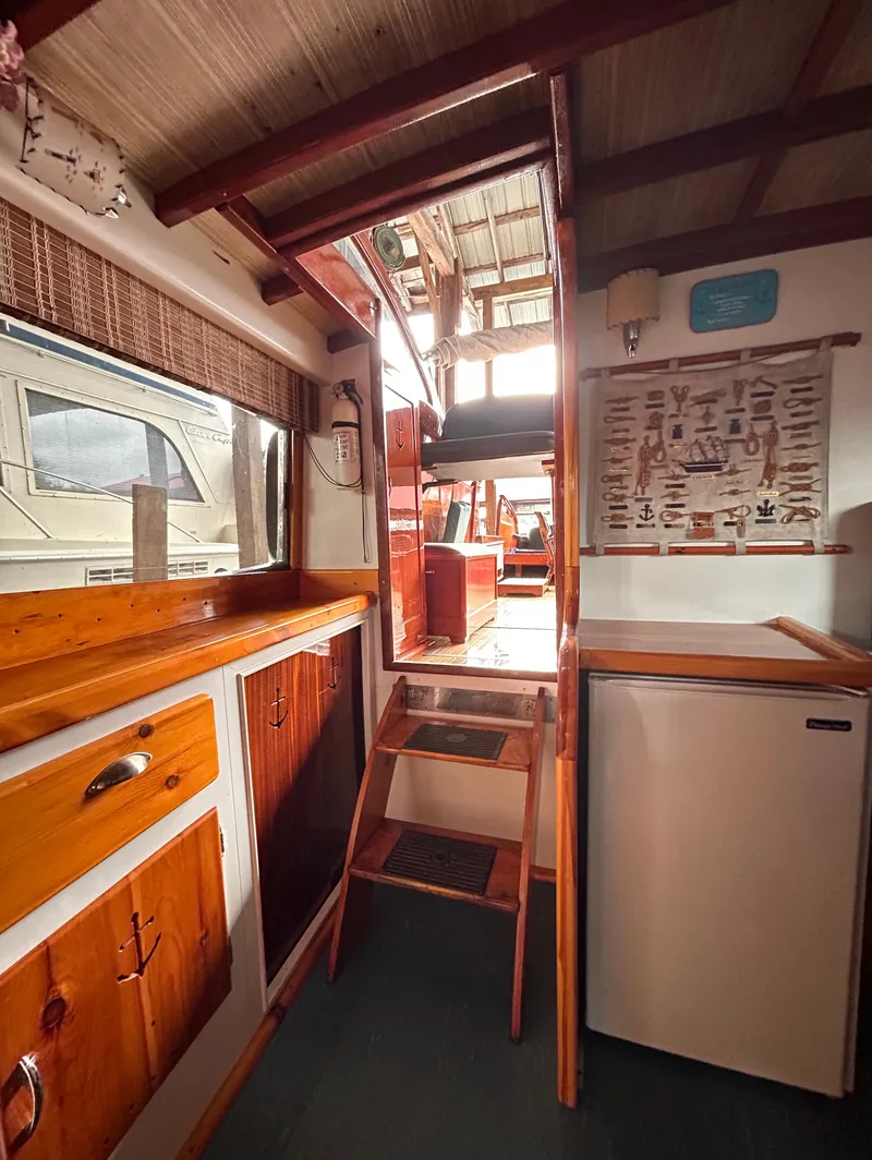 Slide: The Image of Interior of 1954 Chris-Craft Commander 336 Express Cruiser with wooden cabinetry and compact kitchen. - 40