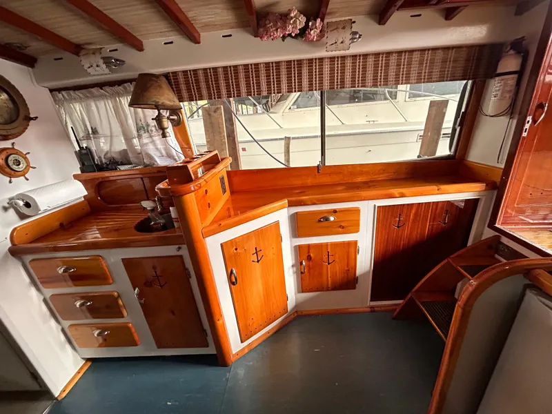 Slide: The Image of Vintage 1954 Chris-Craft Commander 336 Express Cruiser interior with wooden cabinetry and nautical decor. - 42