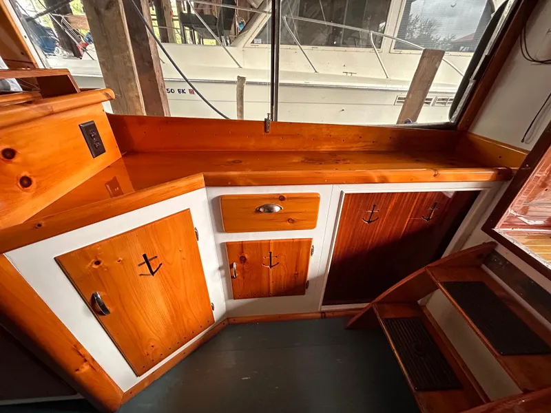 Slide: The Image of Wooden interior of a 1954 Chris-Craft Commander 336 Express Cruiser with cabinets and stairs. - 43