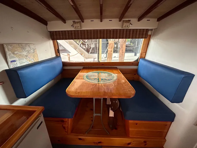 Slide: The Image of Interior of 1954 Chris-Craft Commander 336 Express Cruiser with blue seating and wooden table. - 47