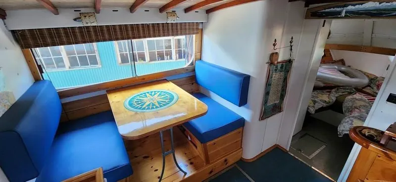 Slide: The Image of 1954 Chris-Craft Commander 36 Express Cruiser interior with blue seating and wooden table. - 49