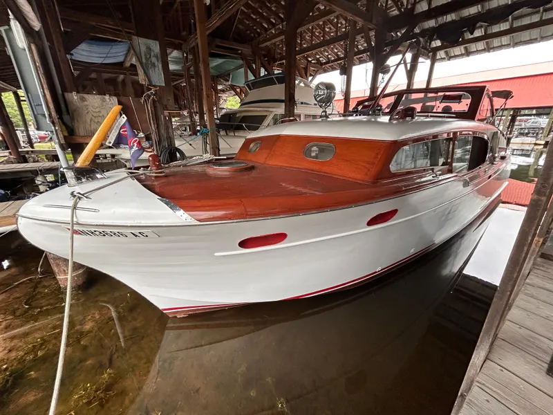 Slide: The Image of 1954 Chris-Craft Commander 336 Express Cruiser docked in a covered marina. - 5