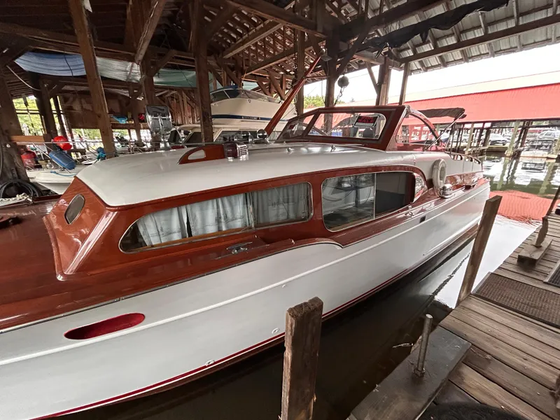 Slide: The Image of 1954 Chris-Craft Commander 336 Express Cruiser docked in a wooden boathouse. - 6