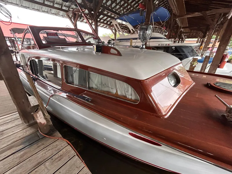 Slide: The Image of 1954 Chris-Craft Commander 336 Express Cruiser docked in a covered marina. - 8