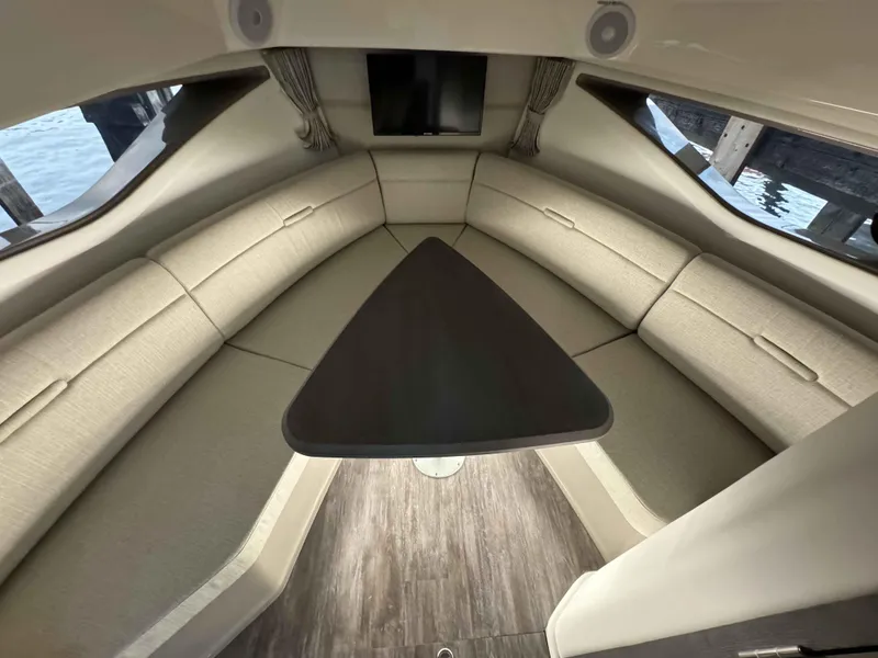 Slide: The Image of Luxurious interior of 2024 Sea Ray 320DA yacht with elegant seating and table. - 12