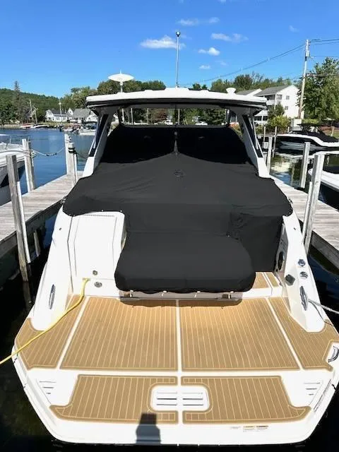 Slide: The Image of 2024 Sea Ray 320DA boat docked, covered, with teak deck. - 16