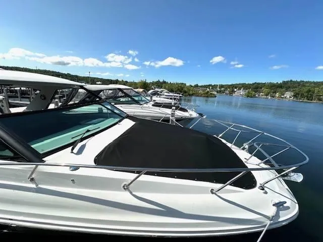 Slide: The Image of 2024 Sea Ray 320DA boat docked on a sunny day by a serene lake. - 17