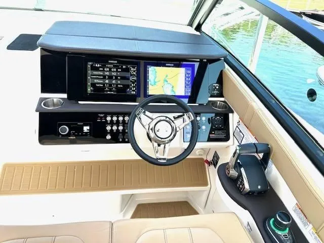 Slide: The Image of 2024 Sea Ray 320DA helm with modern navigation displays and controls. - 24