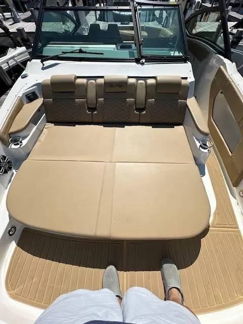 Slide: The Image of 2024 Sea Ray 320DA boat interior with tan seating and deck. - 25